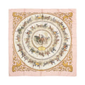 Hermès Carré 90 pink silk scarf with circular horse-drawn carriage illustrations, gold ornate border, and “Hermès Paris” text at bottom