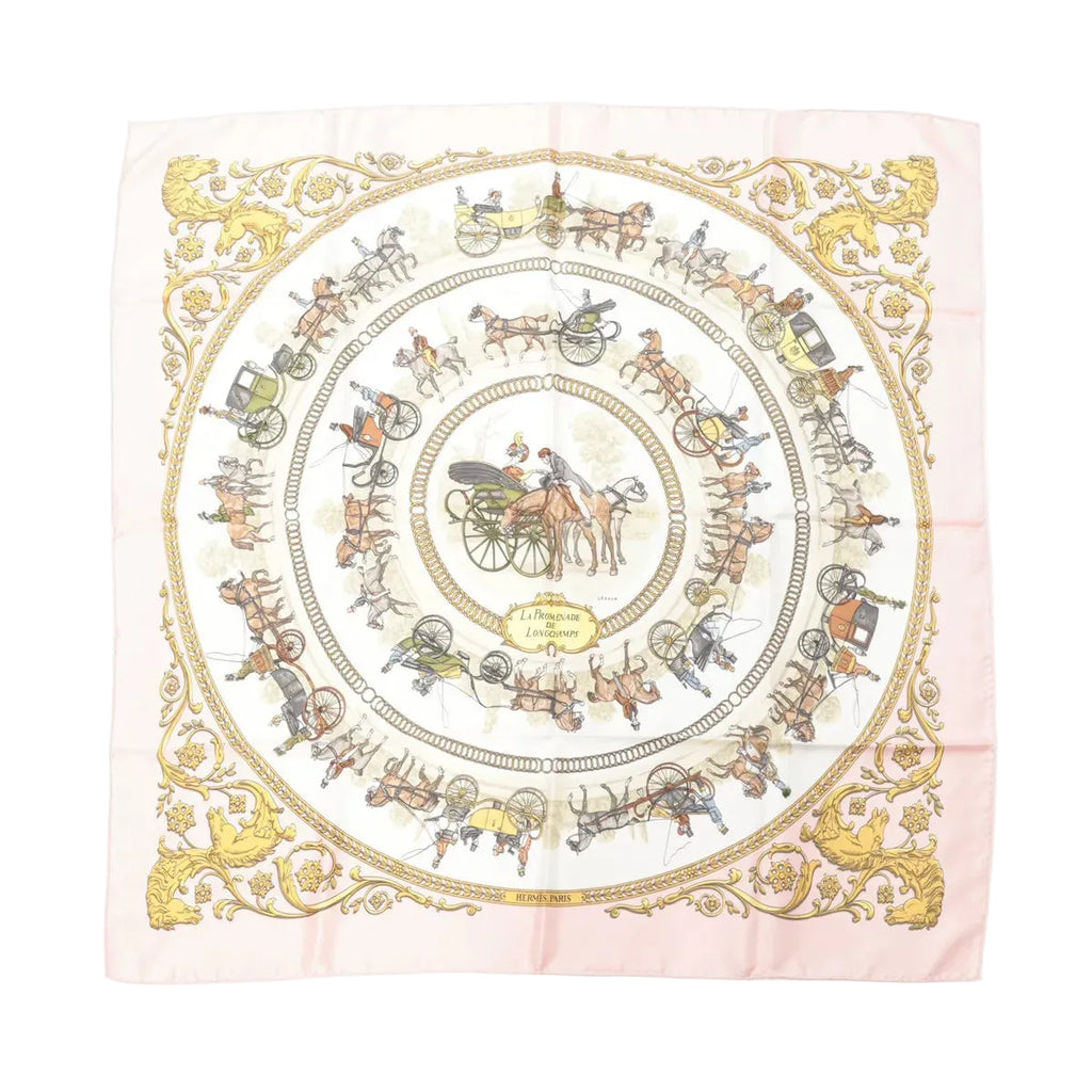 Hermès Carré 90 pink silk scarf with circular carriage and horse illustrations and ornate gold border, laid flat