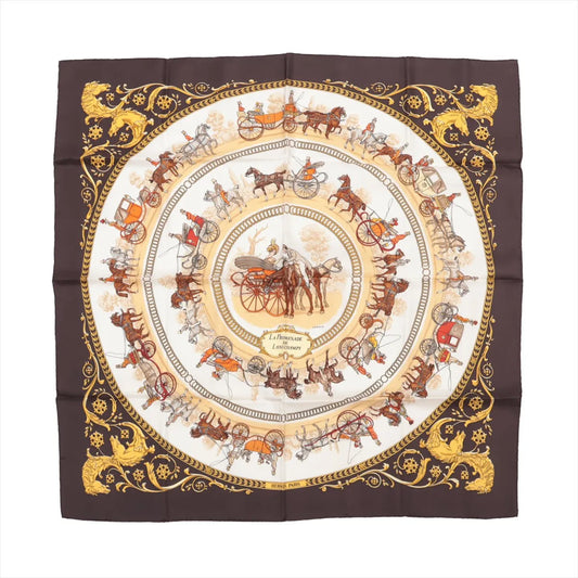 Hermès Carré 90 silk scarf titled "La Promenade de Longchamps," featuring concentric circles of detailed horse-drawn carriages and riders in brown, gold, and red tones on a cream background, framed by an ornate brown and gold border with lion motifs.
