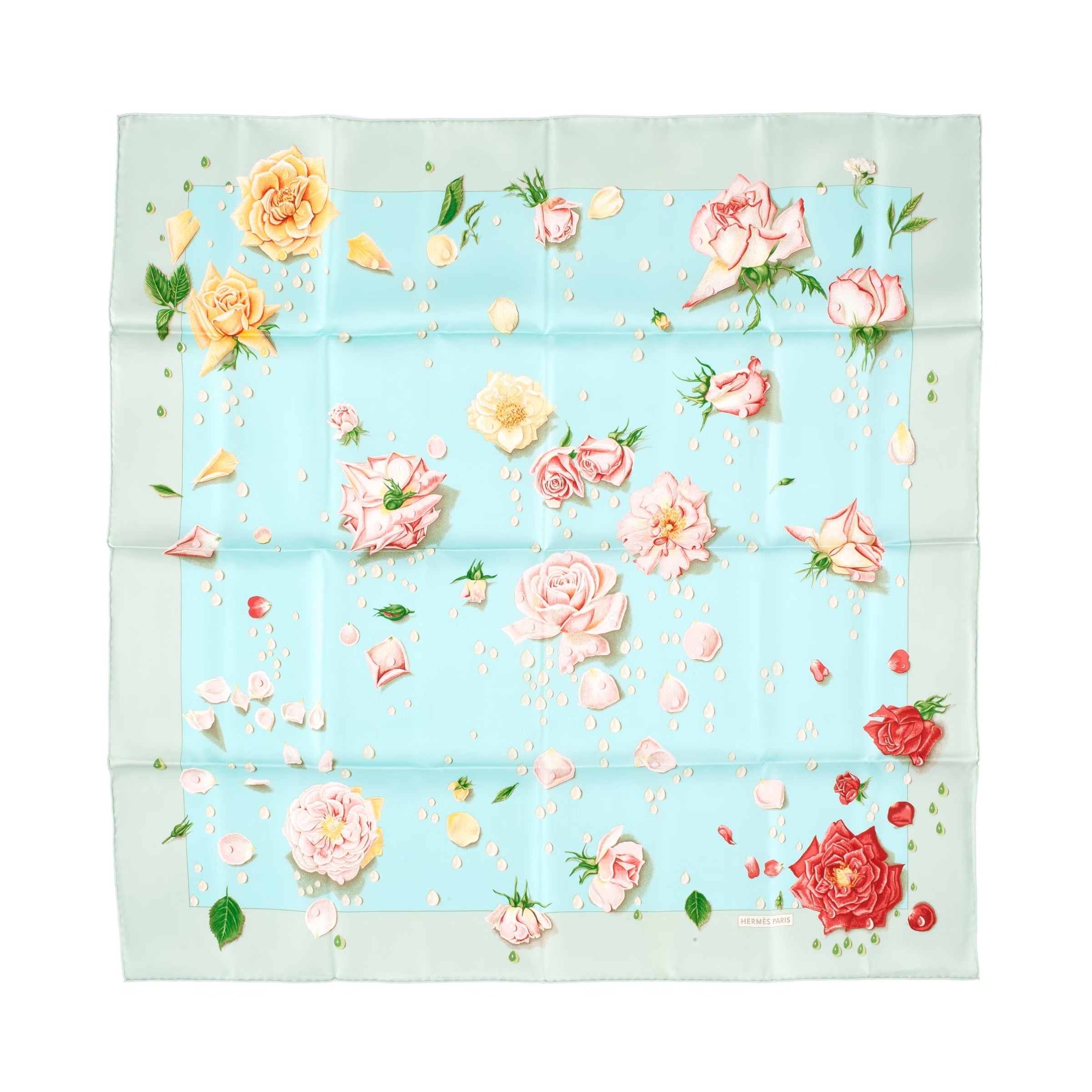 Hermès Carré 90 La Rosée silk scarf in pale blue with pink, yellow, and red rose print, scattered petals, light green border, and visible fold lines on white background.