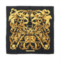 Hermès Carré 90 black silk scarf with ornate gold baroque scrollwork, tassel motifs, and central equestrian bit design on white background