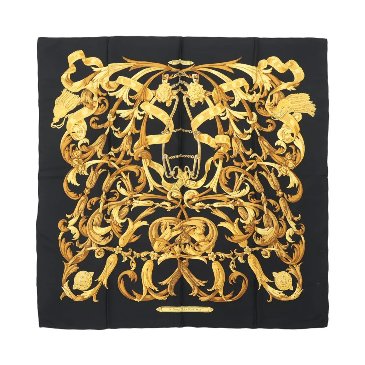 Hermès Carré 90 black silk scarf with ornate gold baroque scrollwork, tassel motifs, and central equestrian bit design on white background