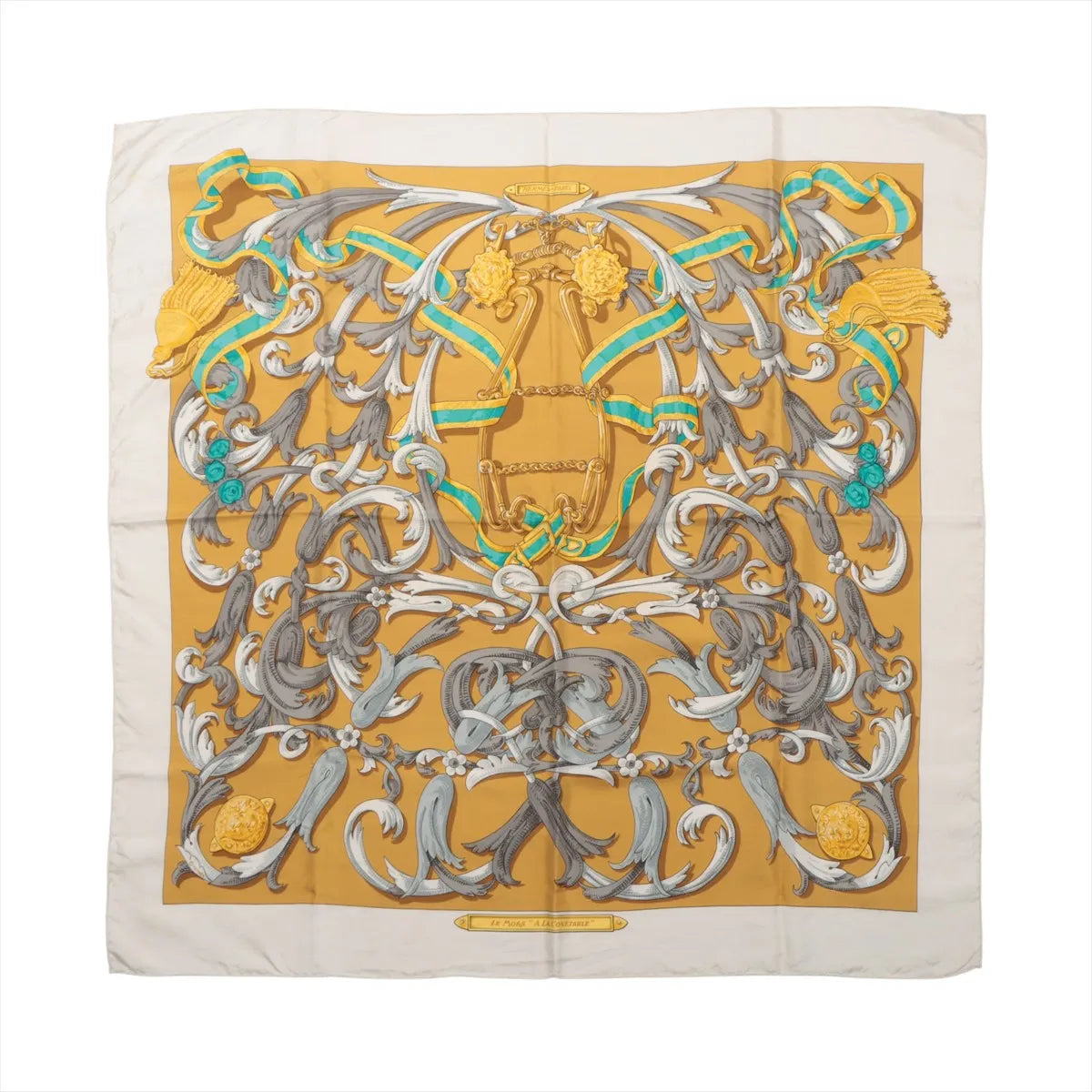 Hermès Carré 90 "Le Mors à la Conétable" silk scarf in yellow with elaborate equestrian bridle motif in gray, white, gold, and green, framed by a cream border.