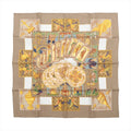 Beige Hermès Carré 90 silk scarf with illustrated tarot cards, symbolic figures, geometric panels and gold-toned motifs.