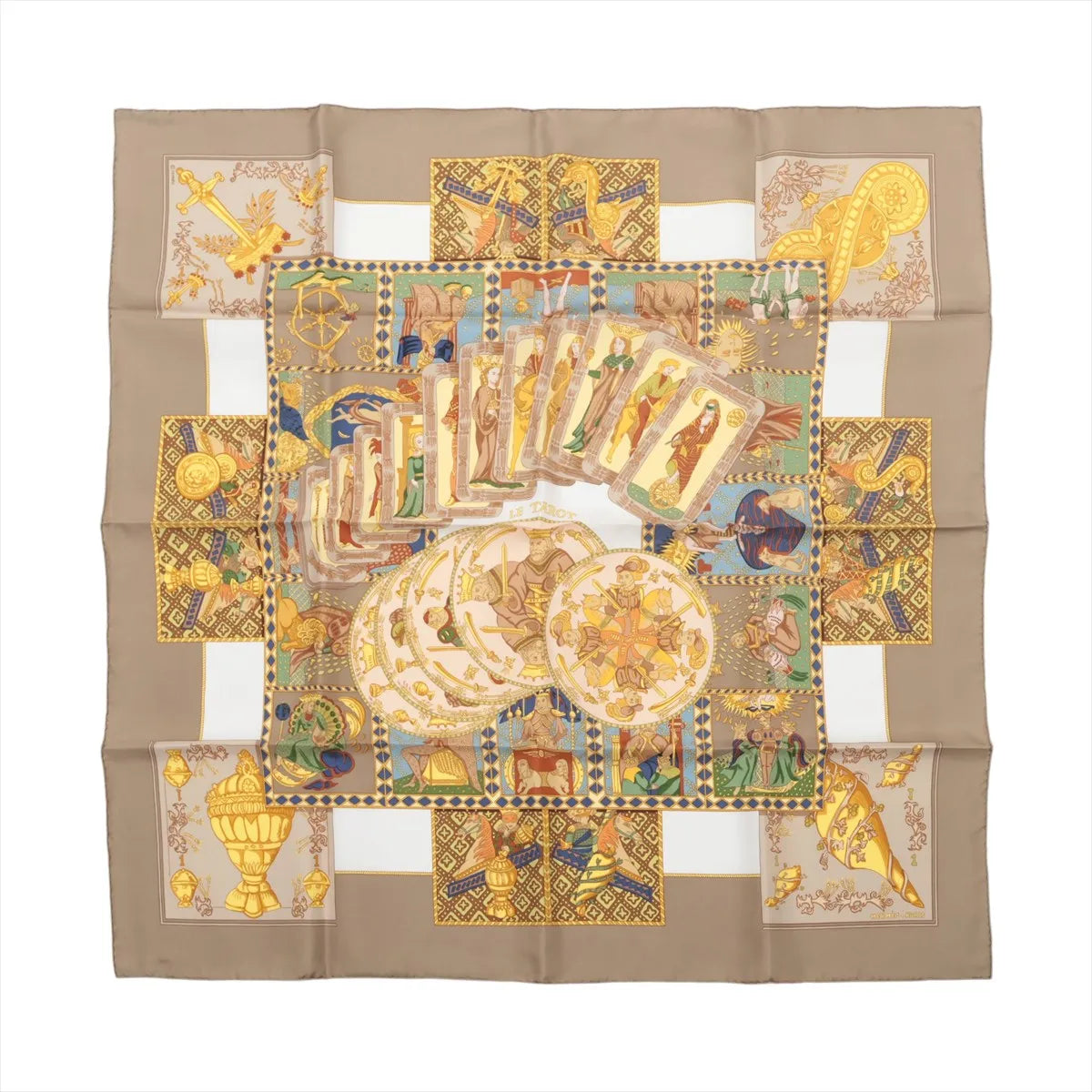 Beige Hermès Carré 90 silk scarf with illustrated tarot cards, symbolic figures, geometric panels and gold-toned motifs.