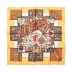 Hermès Carré 90 yellow silk scarf with layered tarot cards, circular playing cards and symbolic red, green, black and brown illustrations.
