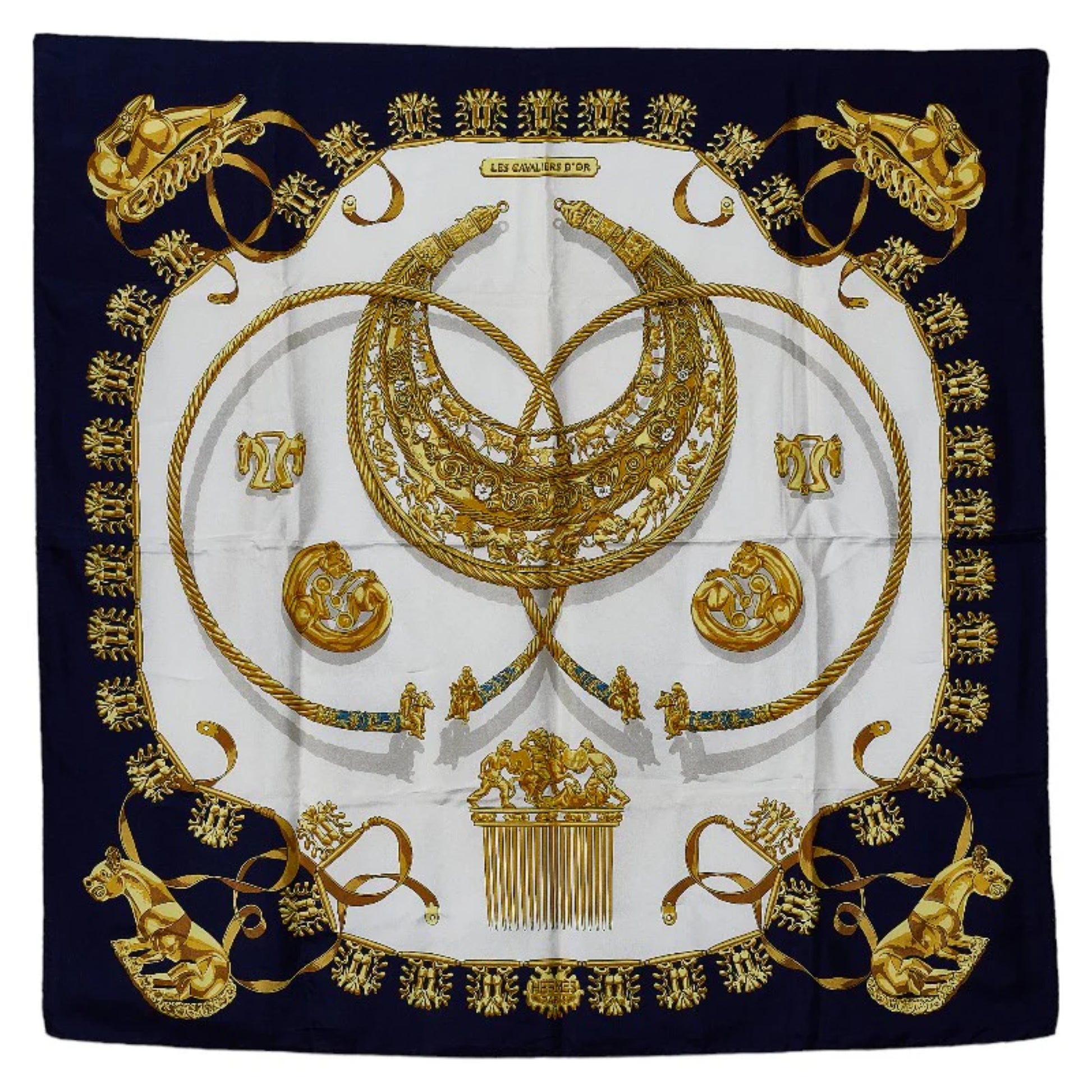 Hermès Carré 90 “Les Cavaliers d'Or” silk scarf in navy blue with a central gold motif of intertwined horse-themed ornaments, medallions, and regal details on a white background.