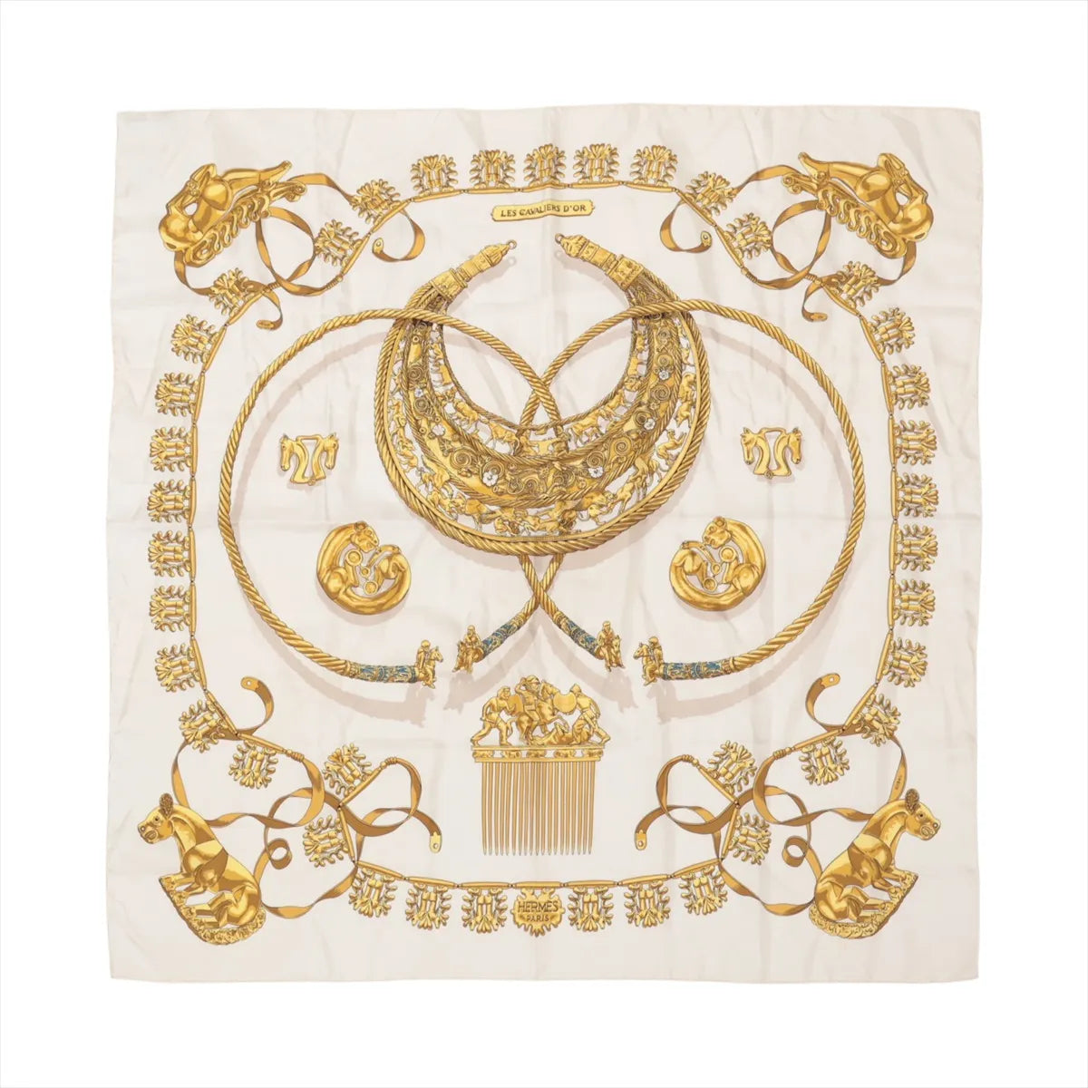 Hermès Carré 90 "LES CAVALIERS D'OR" silk scarf in white, featuring intricate gold illustrations of horse-themed jewelry, including medallions, combs, and collars, arranged symmetrically with rope-like borders and ornate ribbon accents.