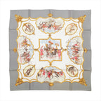 Gray Hermès Carré 90 silk scarf with ornate gold framing, horse and rider scenes, and ivory, red and blue accents.
