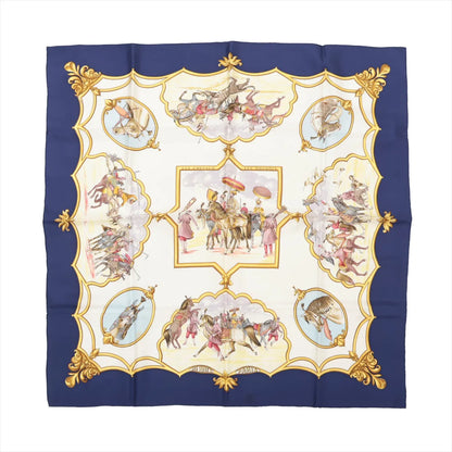 Hermès Carré 90 silk scarf titled "Les Chevaux des Moghols," featuring detailed illustrations of Mughal horsemen in ceremonial attire, surrounded by decorative gold frames and corner accents, all set against a cream background with a navy blue border.
