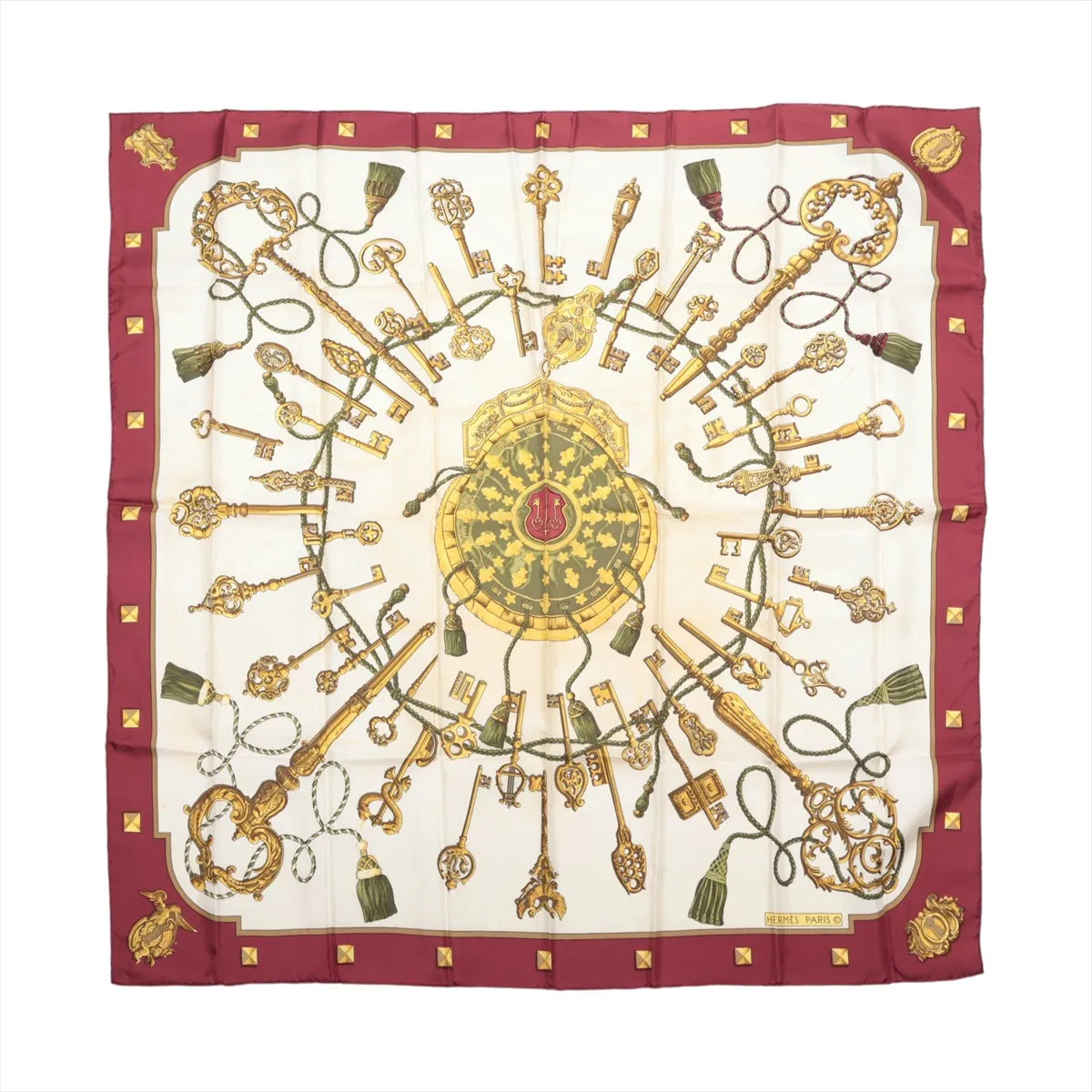 Hermès Carré 90 burgundy and ivory silk scarf with ornate gold key motifs, green tassels, a central circular medallion and burgundy border.