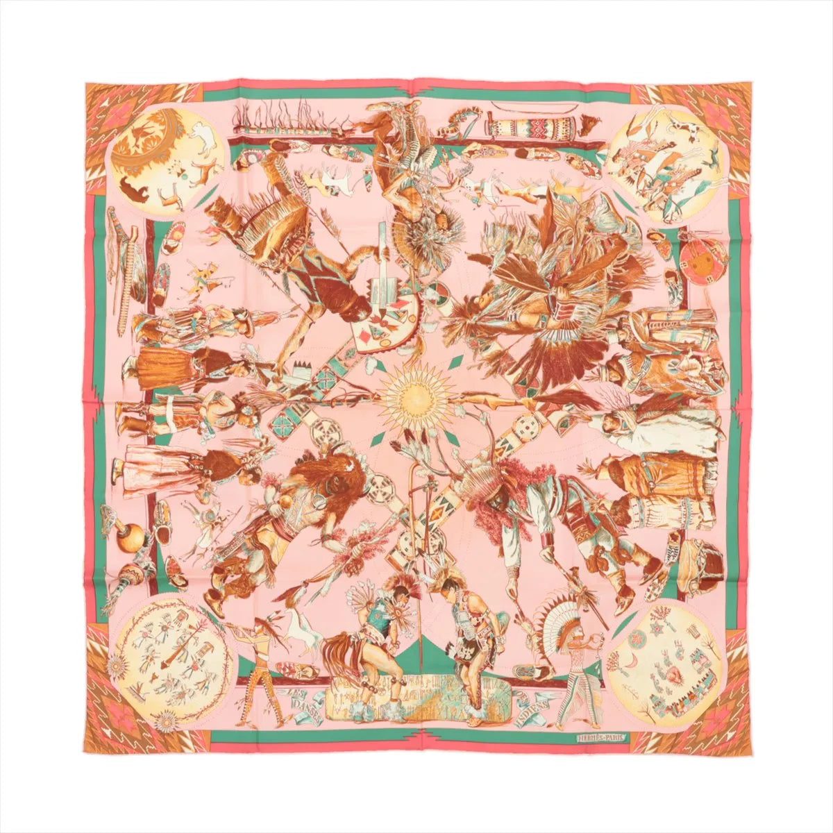 Hermès Carré 90 "LES DANSES DES INDIENS" silk scarf in pink featuring detailed illustrations of Native American dancers in traditional regalia, ceremonial scenes, and symbolic motifs, all framed by a green and red border with intricate cultural elements.