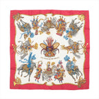 Hermès Carré 90 silk scarf titled "Les Fêtes du Roi Soleil," featuring elaborately costumed figures on horseback in vibrant red, gold, and blue tones, set against a cream background with a rich red border and ornate decorative flourishes.