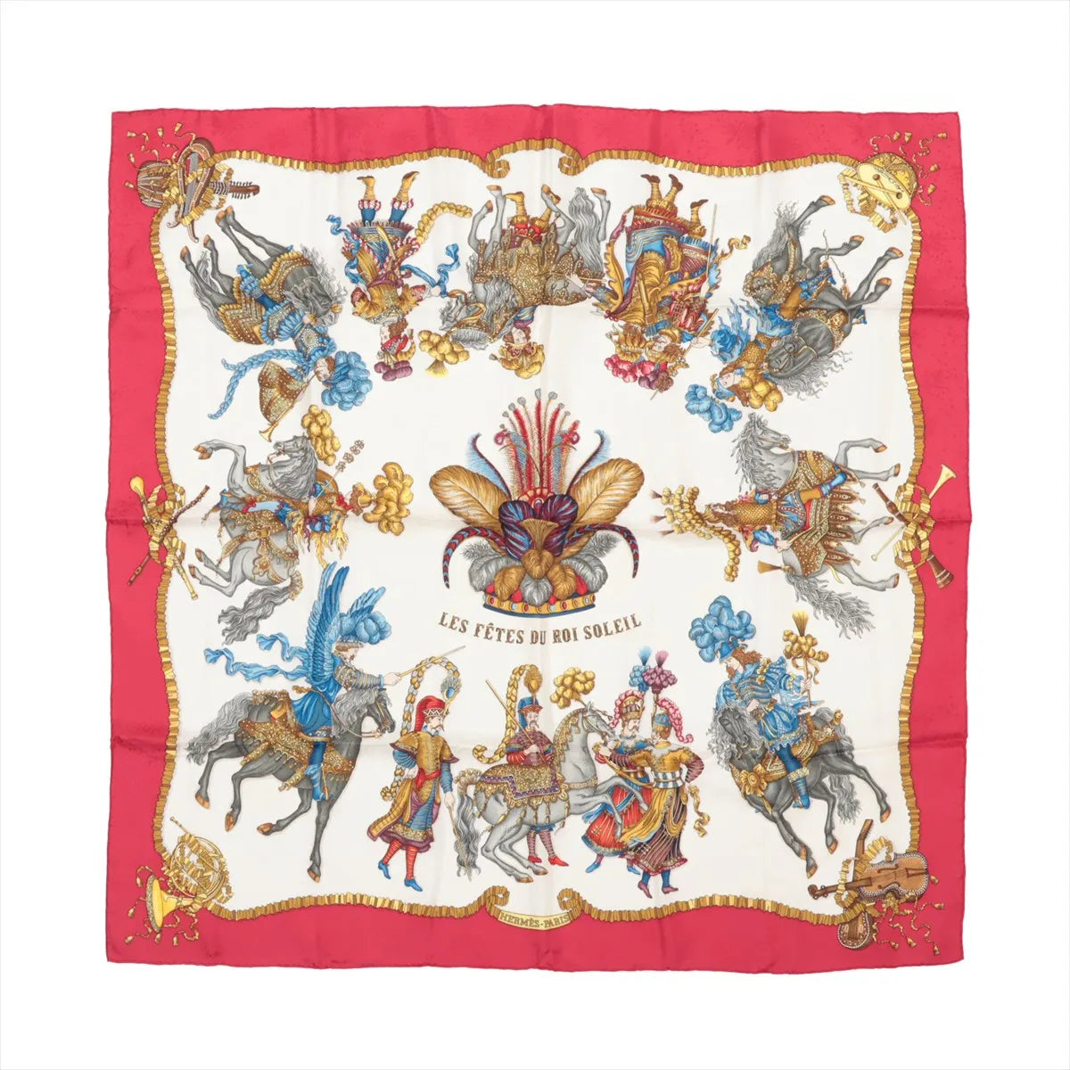 Hermès Carré 90 silk scarf titled "Les Fêtes du Roi Soleil," featuring elaborately costumed figures on horseback in vibrant red, gold, and blue tones, set against a cream background with a rich red border and ornate decorative flourishes.