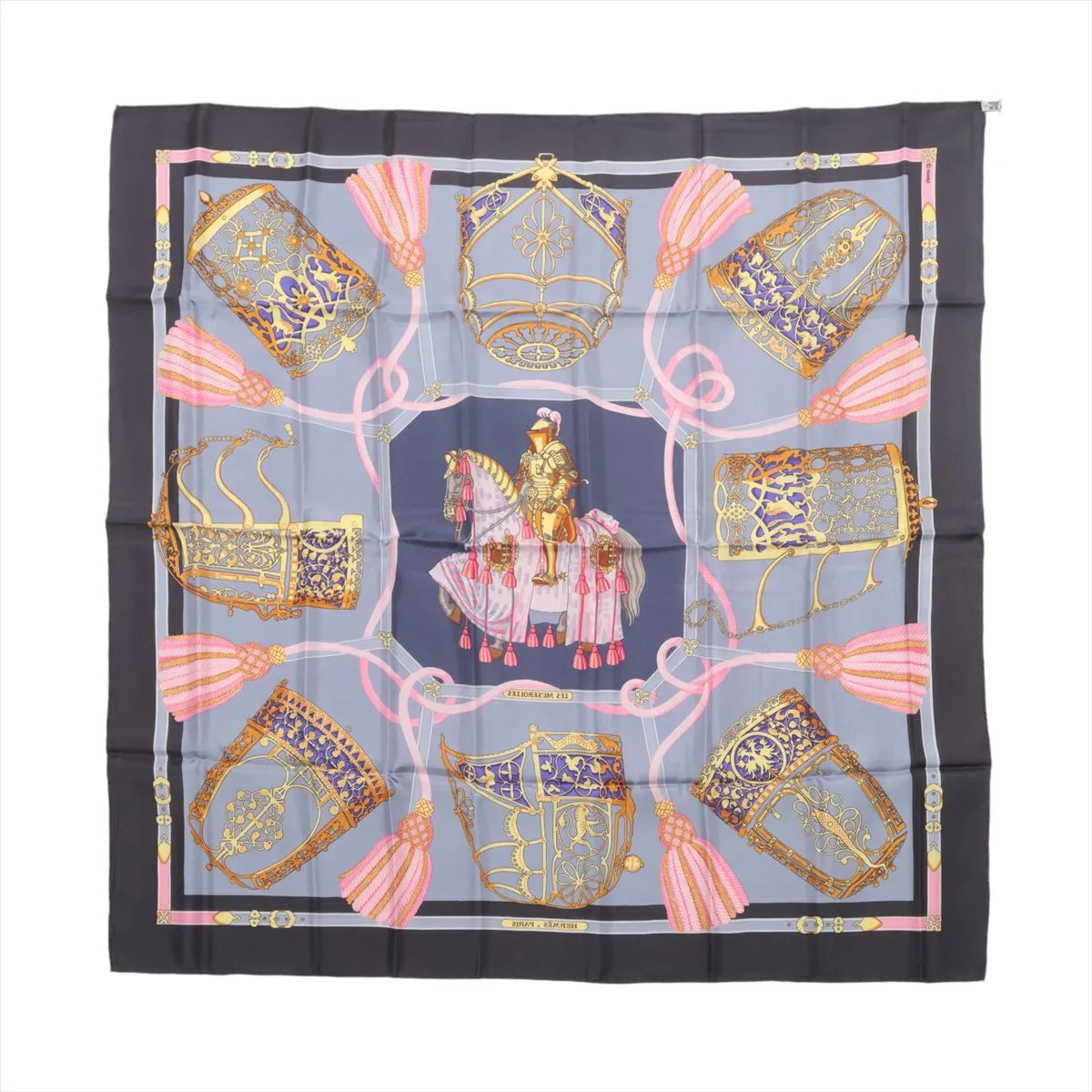 Gray Hermès Carré 90 silk scarf with ornate gold equestrian motifs, central horse and rider, pink tassels and dark navy border.