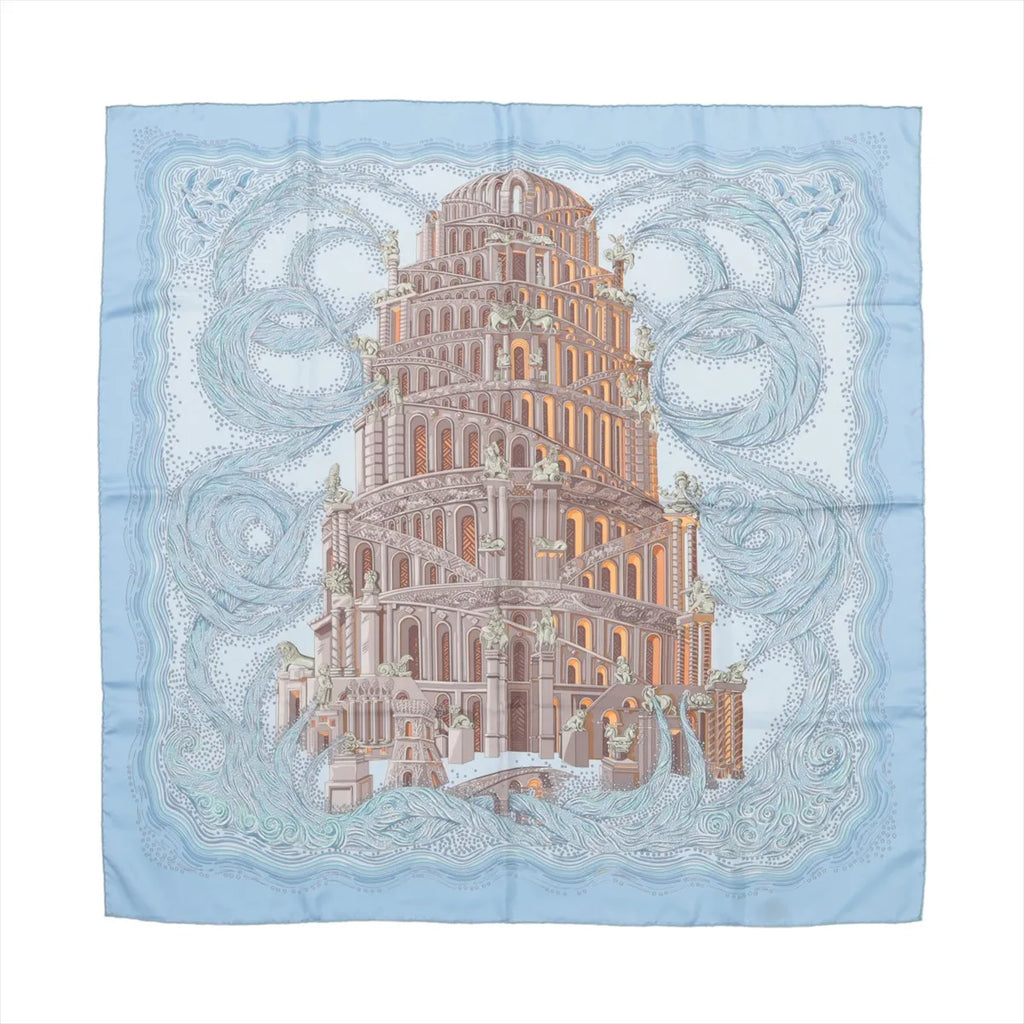 Hermès Carré 90 "Les Rivières de Babel" silk handkerchief in light blue featuring an elaborate tower with architectural details surrounded by swirling river designs.