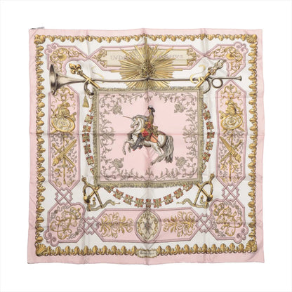 Hermès Carré 90 "LVDOVICVS MAGNVS" silk scarf in pink featuring a central image of Louis XIV on horseback, surrounded by ornate baroque patterns, trumpets, swords, and decorative flourishes in gold tones.