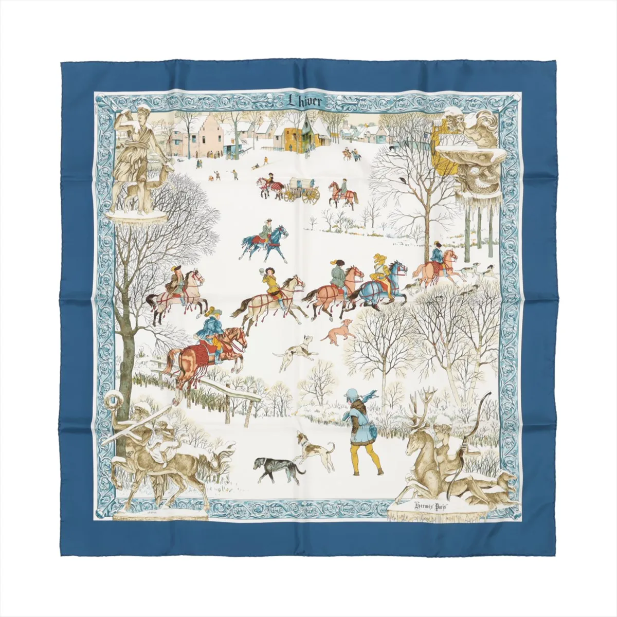 Top-down view of Hermès Carré 90 "L'hiver" silk handkerchief in blue, depicting a detailed winter scene with horse riders, hounds, trees, and snowy landscapes, all bordered by an intricate blue and white frame.