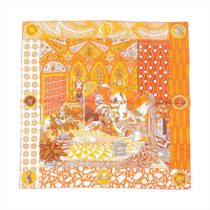 Hermès Carré 90 “La Danse des Amazones” silk scarf in orange, illustrating a vivid scene of Amazonian figures, leopards, and tropical plants within a patterned palace interior.