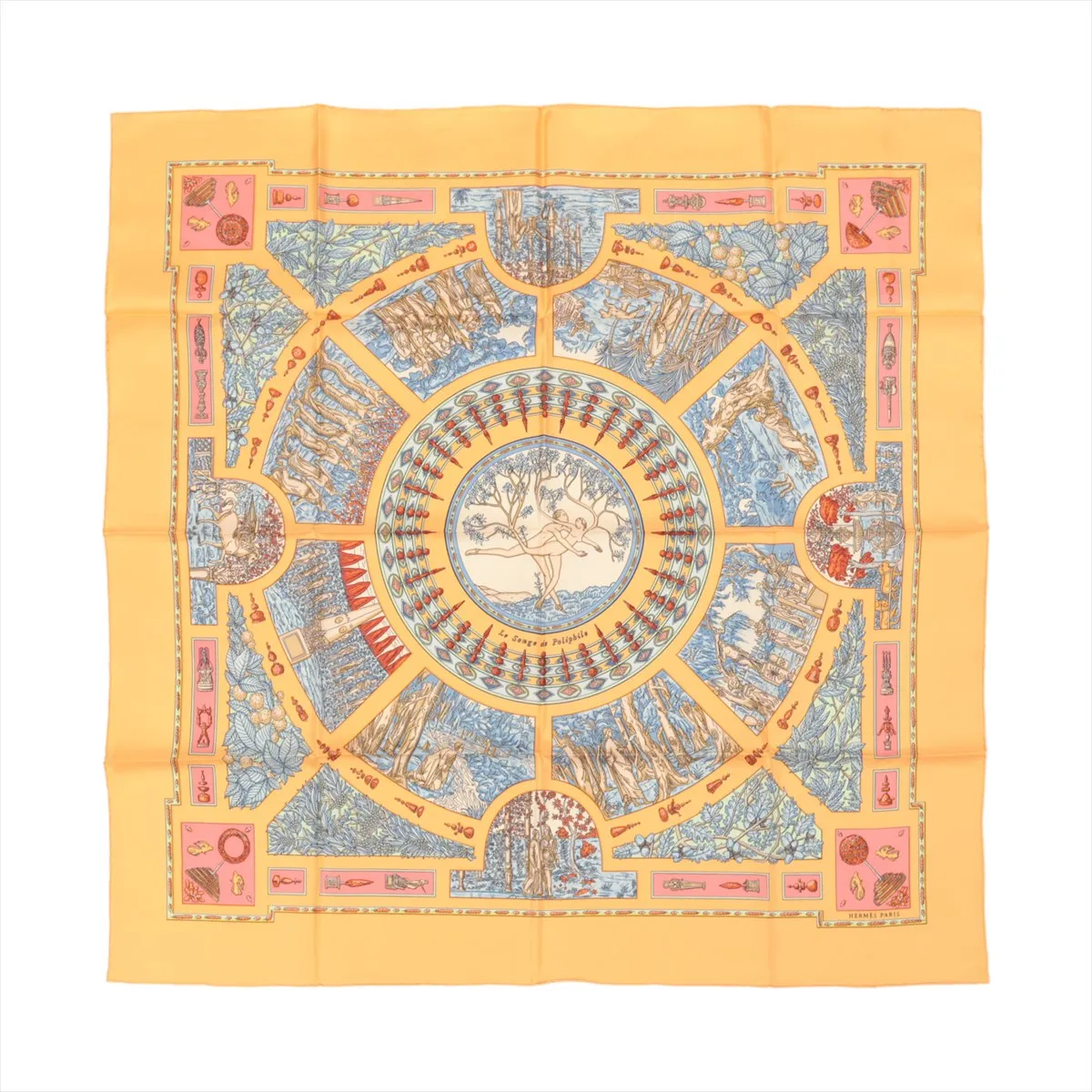Top-down view of an Hermès Carré 90 "Le Songe de Poliphile" silk handkerchief in orange, featuring a detailed circular illustration with classical motifs in blue, red, and cream tones, bordered by geometric and symbolic artwork.