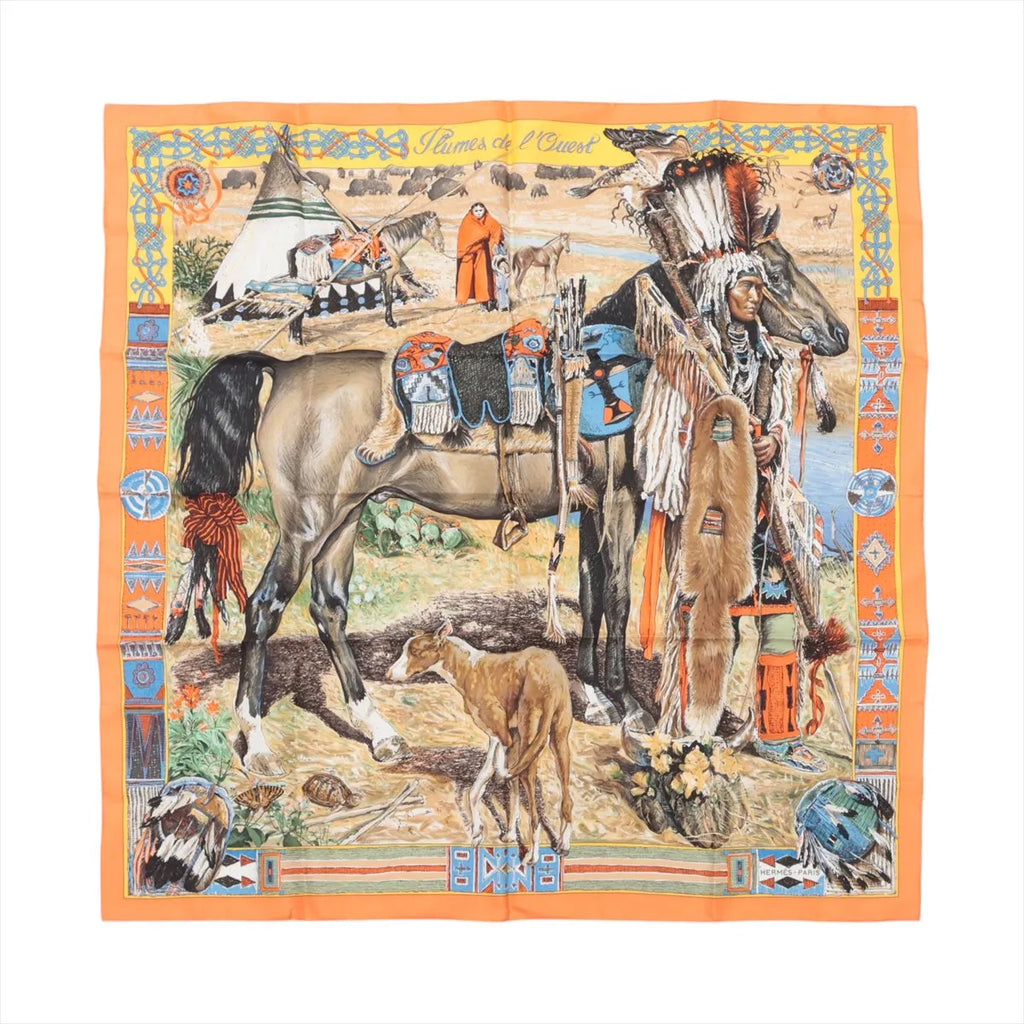 Hermès Carré 90 silk scarf in orange with an illustrated scene featuring a horse, foal, tipi, and figure, bordered by decorative multicolor motifs, laid flat on white background.