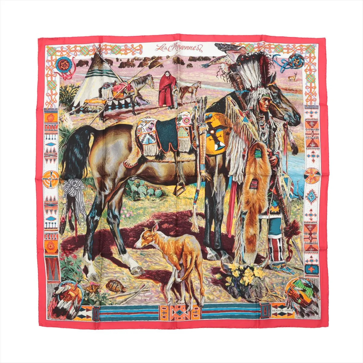 Hermès Carré 90 silk scarf titled "Les Cheyennes," featuring a detailed depiction of a Native American scene with a Cheyenne chief in traditional regalia, horses, a tipi village, bison in the background, and a red border adorned with tribal patterns and symbols.