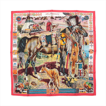 Hermès Carré 90 silk scarf titled "Les Cheyennes," featuring a detailed depiction of a Native American scene with a Cheyenne chief in traditional regalia, horses, a tipi village, bison in the background, and a red border adorned with tribal patterns and symbols.