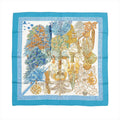 Hermès Carré 90 blue silk scarf with “Les Légendes de L’Arbre” botanical tree illustration in blue, gold, and cream, framed by a solid blue border and patterned inner border.