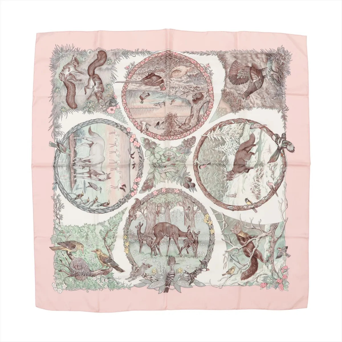 Hermès Carré 90 "Les Quatre Saisons" silk handkerchief in soft pink, featuring intricately illustrated woodland animals and seasonal nature scenes within circular frames, bordered by florals and delicate forest details on a cream background.
