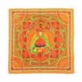 Hermès Carré 90 orange silk scarf with stained-glass style design featuring a central winged figure, green scrollwork, and intricate floral and geometric border details.