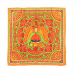 Hermès Carré 90 orange silk scarf with stained-glass style design featuring a central winged figure, green scrollwork, and intricate floral and geometric border details.