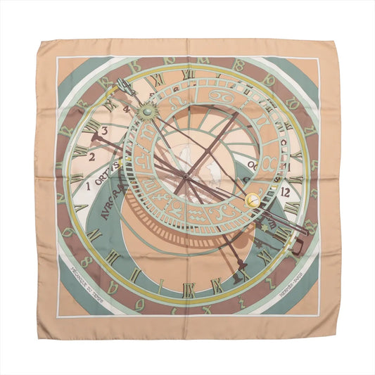 Hermès Carré 90 "MECANIQUE DU TEMPS" silk scarf in beige with an elaborate clock face, zodiac symbols, and Roman numerals in muted tones.