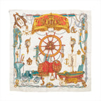 Beige Hermès Carré 90 silk scarf with ornate ship wheel, anchor, saddle, carriage, ropes and gold, coral and turquoise details.