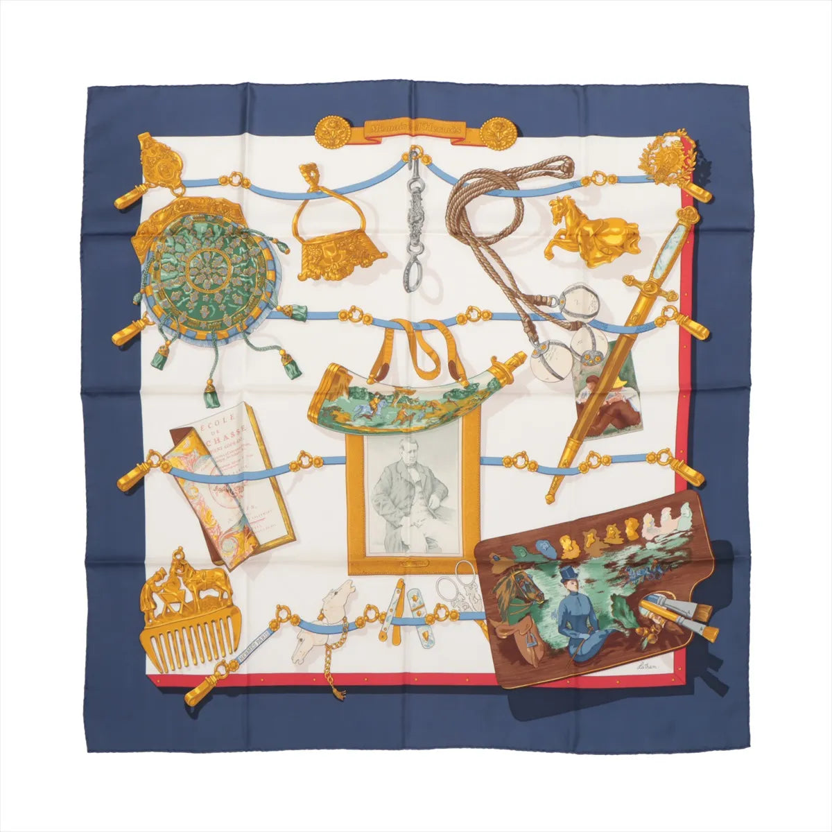 Hermès Carré 90 "Mémoire d'Hermès" silk handkerchief in navy blue showcasing an elaborate arrangement of gold equestrian items, historical artifacts, framed portraits, and scrolls on a cream background with a navy and red border.