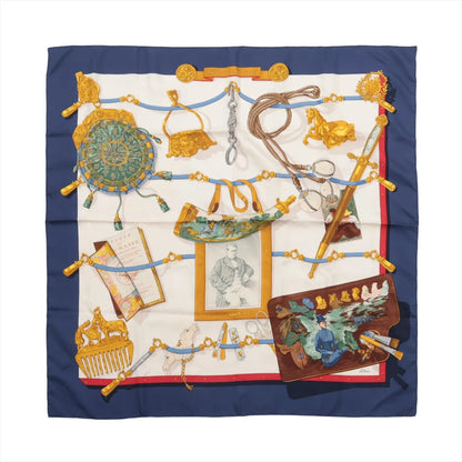 Hermès Carré 90 “Mémoire d’Hermès” silk scarf in navy blue with a cream center, decorated with detailed illustrations of historic objects, portraits, and equestrian-themed collectibles.