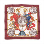 Hermès Carré 90 burgundy silk scarf with “Napoleon” design featuring red and blue uniforms, gold eagles, laurel wreath frames, and sepia equestrian scenes on a cream center.