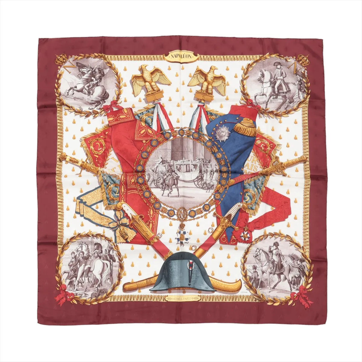 Hermès Carré 90 burgundy silk scarf with “Napoleon” design featuring red and blue uniforms, gold eagles, laurel wreath frames, and sepia equestrian scenes on a cream center.