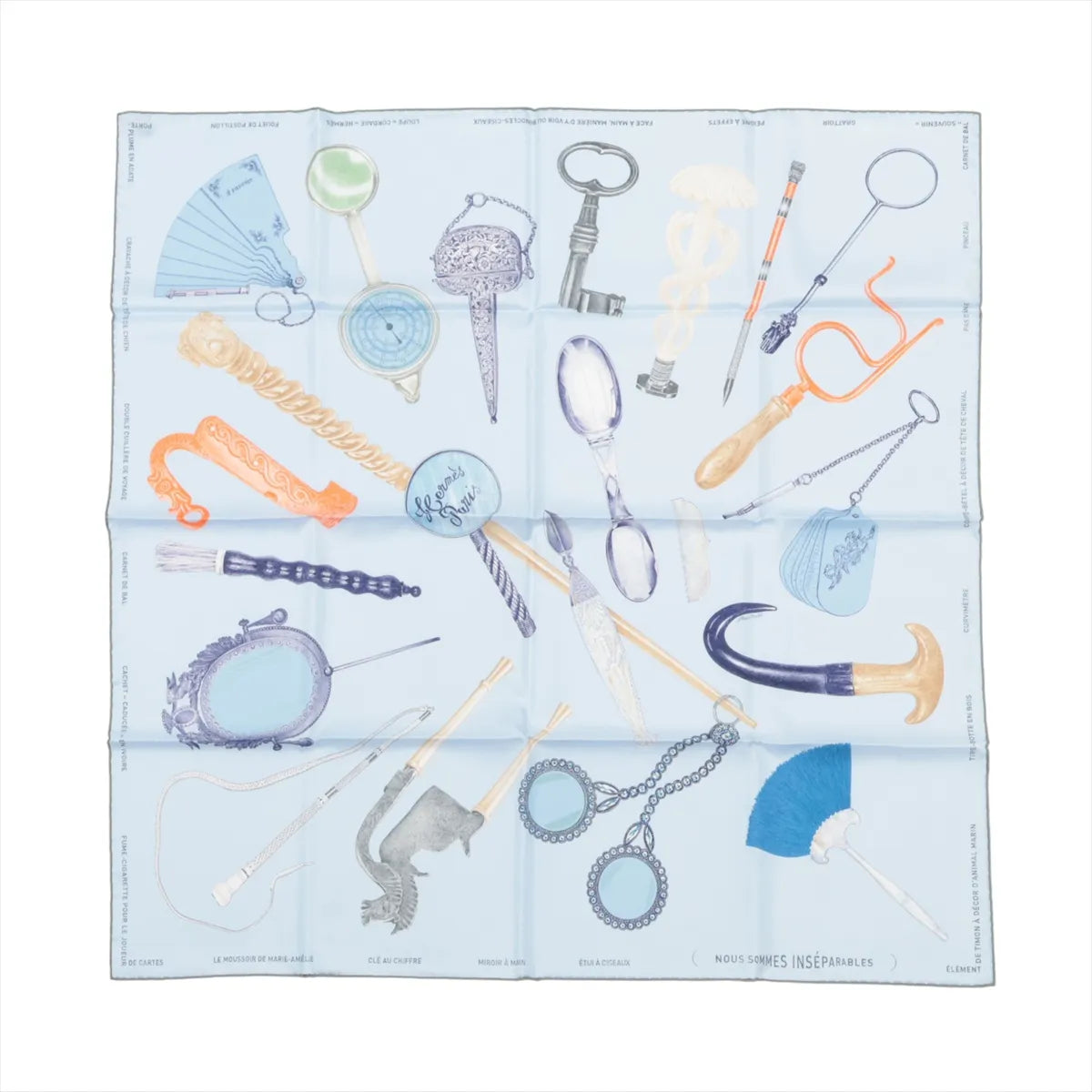 Hermès Carré 90 silk scarf in light blue with illustrated objects and accessories in pastel tones, laid flat on white background.