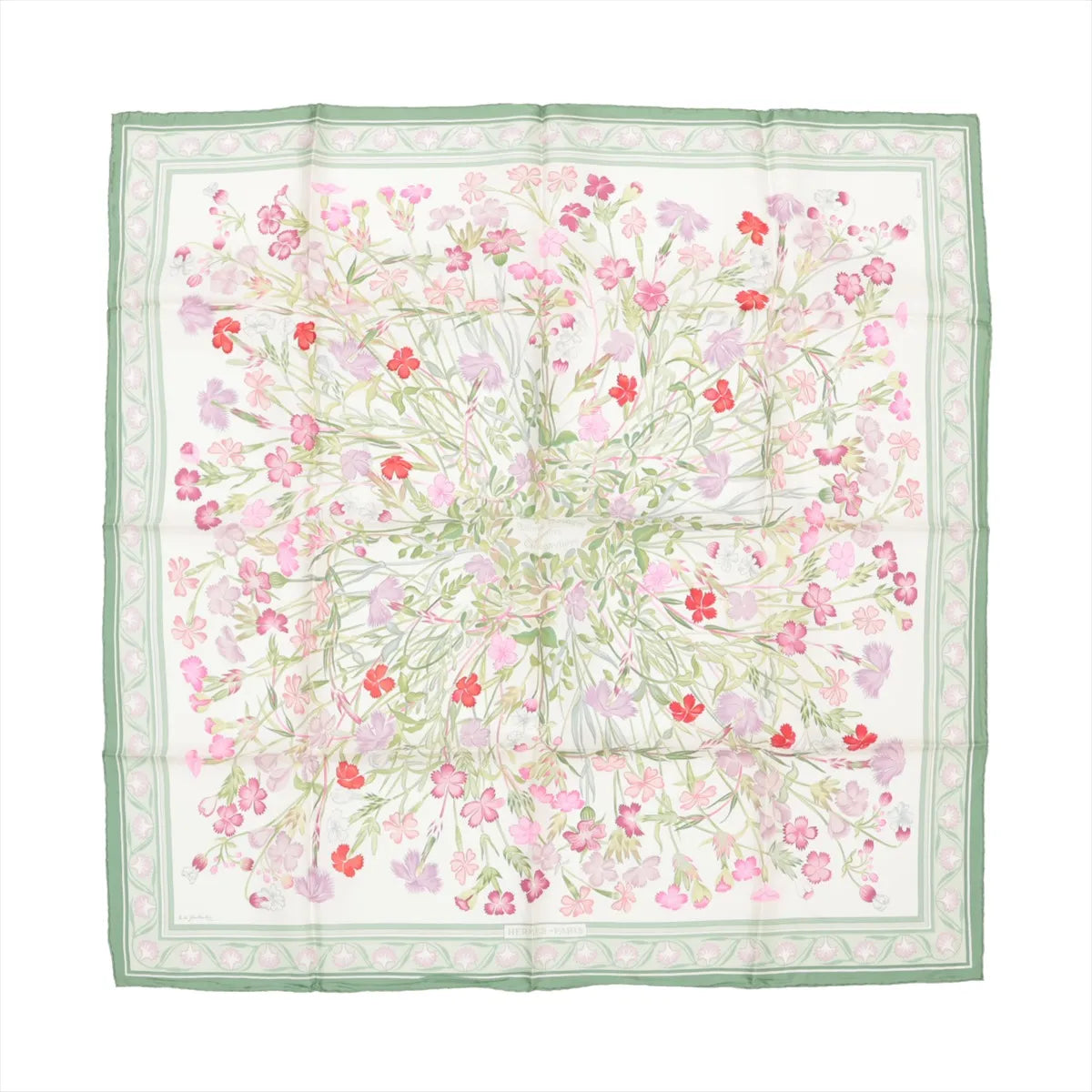 Hermès Carré 90 silk scarf featuring a detailed wild carnation floral design in shades of pink, red, and lilac on a white background, framed by a green and pastel pink border.