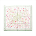 Hermès Carré 90 silk scarf with white background, green border, and delicate pink and red wild carnation floral print, laid flat