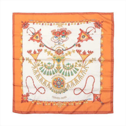 Hermès Carré 90 silk scarf titled “Parures des Sables” featuring intricate, colorful jewelry motifs on a white background with an orange border.
