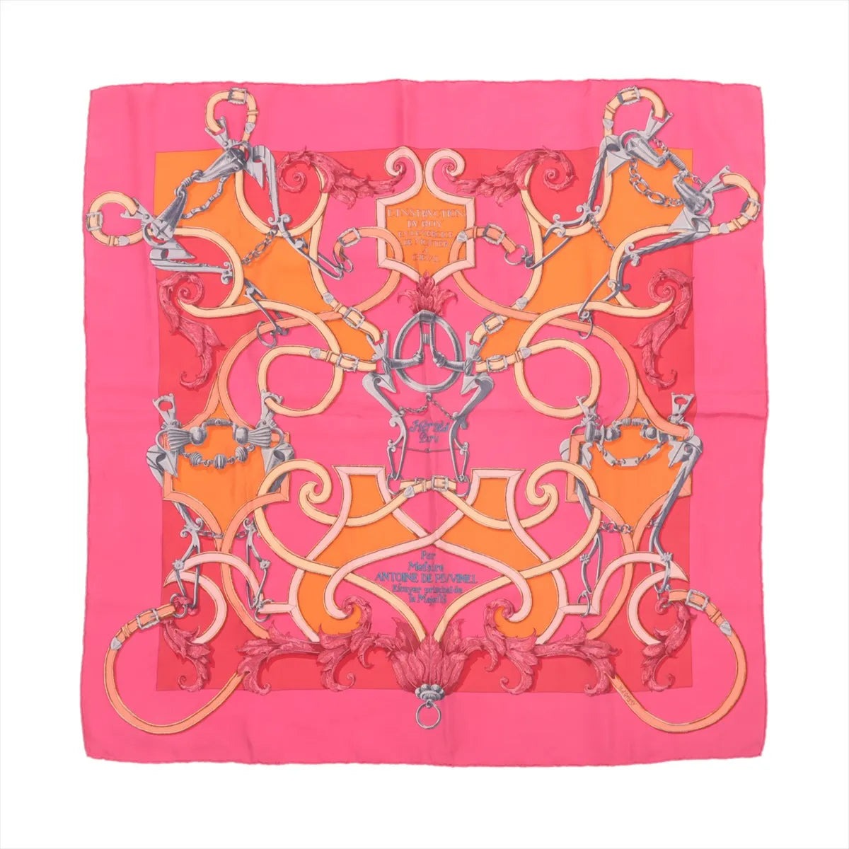 Hermès Carré 90 "L'Instruction du Roy" silk handkerchief in pink featuring intricate orange scroll patterns, silver equestrian bits, and baroque detailing with a central ornamental crest on a vibrant pink and orange background.