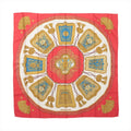 Red Hermès Carré 90 silk scarf with ivory center, turquoise panels and symmetrical gold cavalry-inspired ornaments, tassels and decorative motifs.