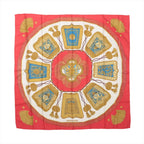 Red Hermès Carré 90 silk scarf with ivory center, turquoise panels and symmetrical gold cavalry-inspired ornaments, tassels and decorative motifs.