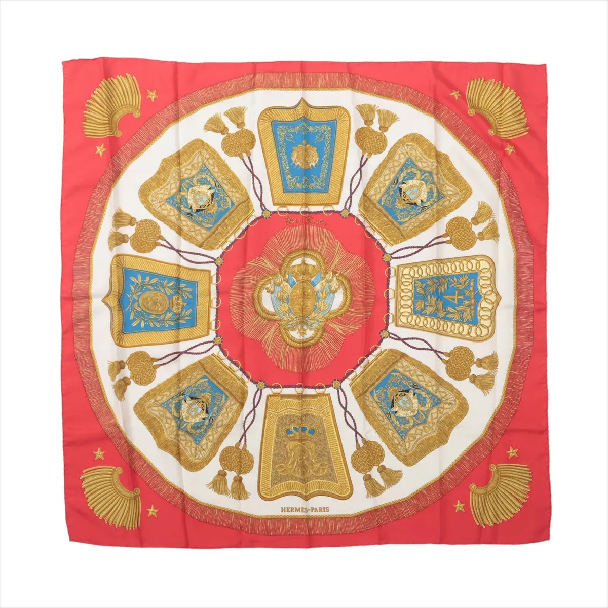 Red Hermès Carré 90 silk scarf with ivory center, turquoise panels and symmetrical gold cavalry-inspired ornaments, tassels and decorative motifs.