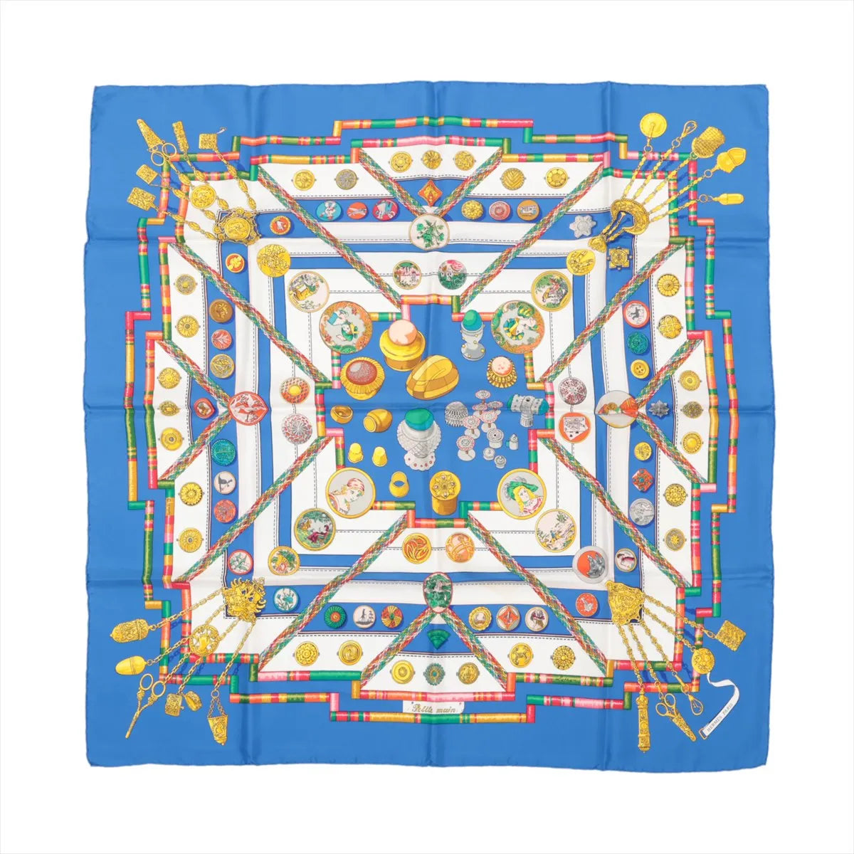 Hermès Carré 90 "Petite Main" silk handkerchief in vibrant blue with detailed illustrations of buttons, sewing tools, and colorful geometric patterns, made from smooth silk and displayed flat against a white background.
