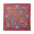Burgundy Hermès Carré 90 silk scarf with multicolor equestrian figures, turquoise outlines and ornate symmetrical decorative motifs.