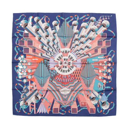 Hermès Carré 90 “D'Orgue” silk scarf in navy blue featuring a colorful organ-inspired design with keyboard, pipes, and geometric abstract patterns in red, coral, turquoise, and white.