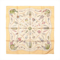Hermès Carré 90 beige silk scarf with an ornate multicolour print of decorative perfume bottles, flacons and small accessories.