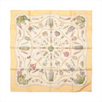 Hermès Carré 90 beige silk scarf with an ornate multicolour print of decorative perfume bottles, flacons and small accessories.